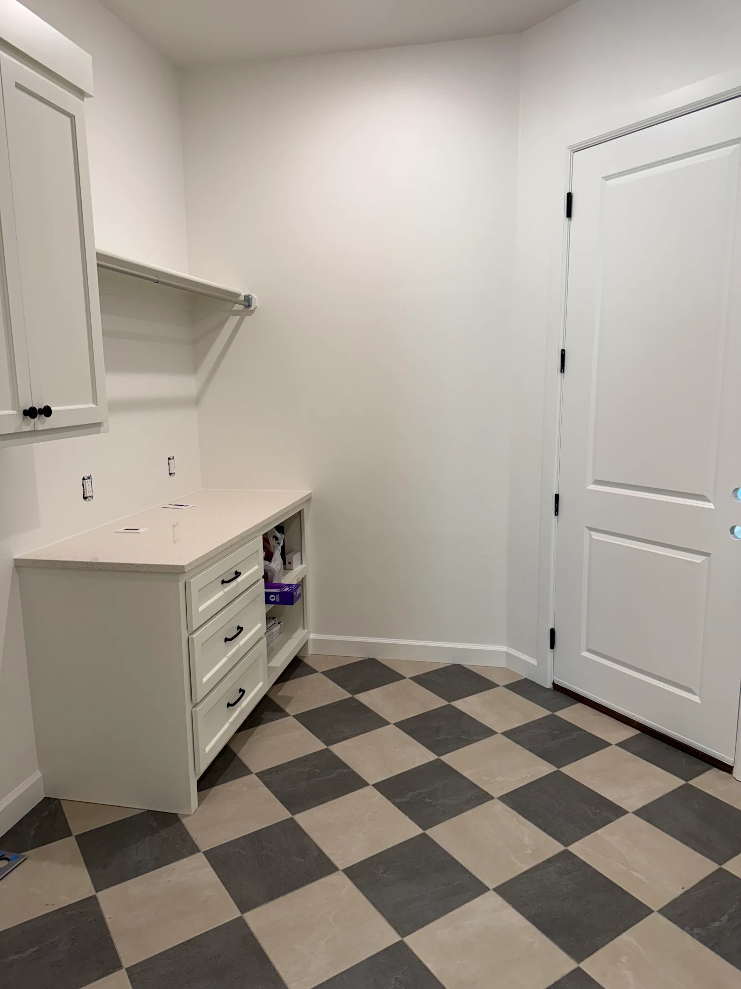 Professional laundry room painting with white cabinets and checkered floor